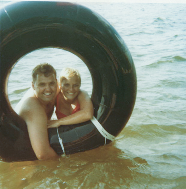 Dave and Lee framed in an inner tube on the lake